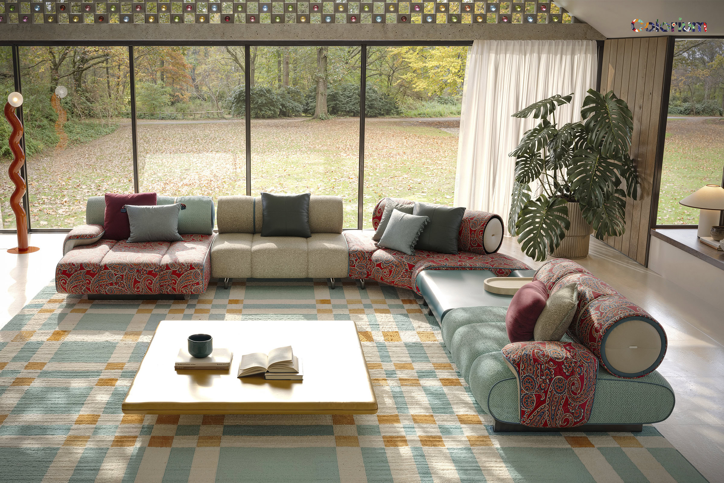 A stylish living room featuring a variety of colorful sofas, a large window with a scenic outdoor view, and contemporary decor including a potted plant and a coffee table.