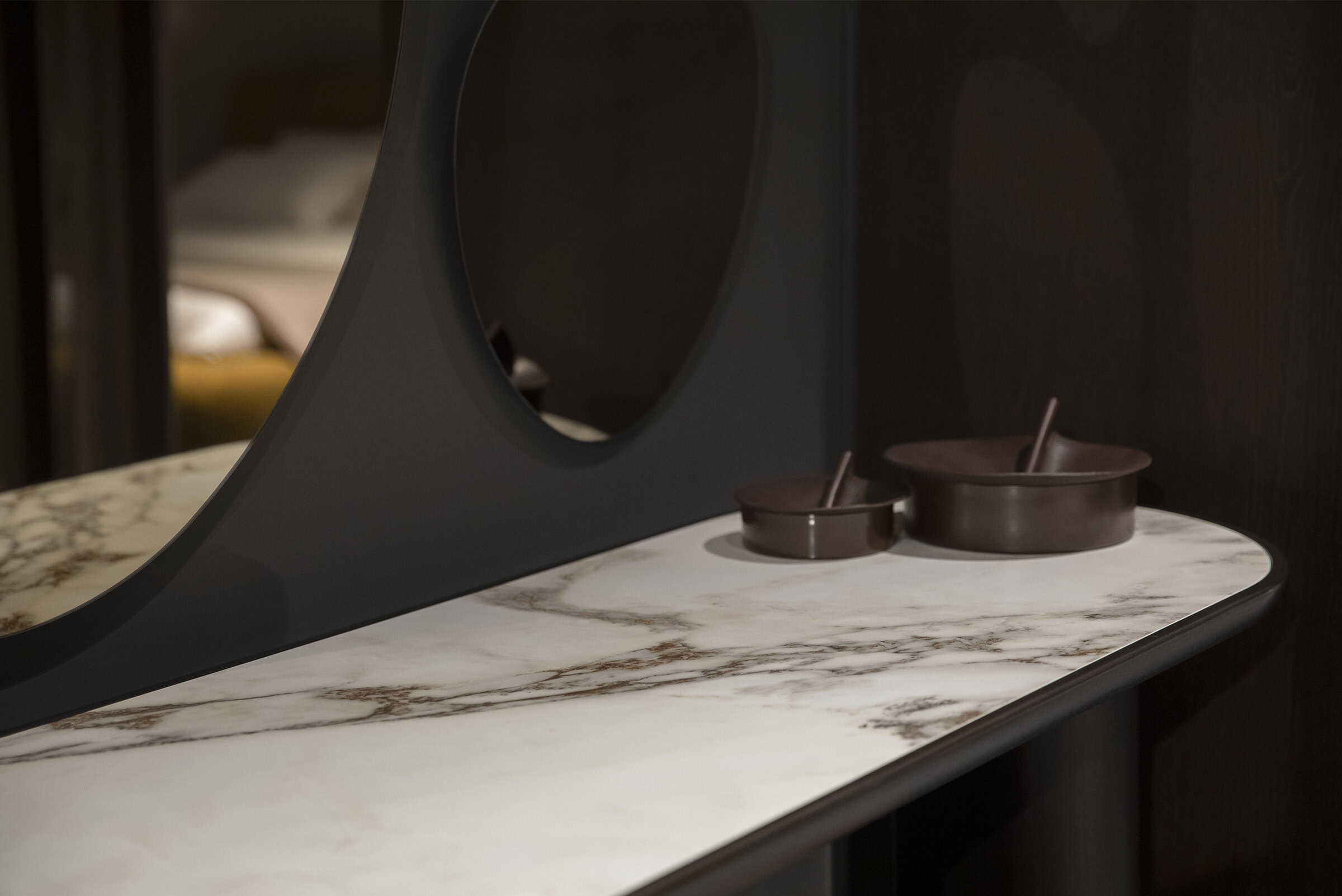 Luxurious marble-top console table with sleek black accents and minimalist decor from Saloni Furniture, perfect for modern and elegant interior design.