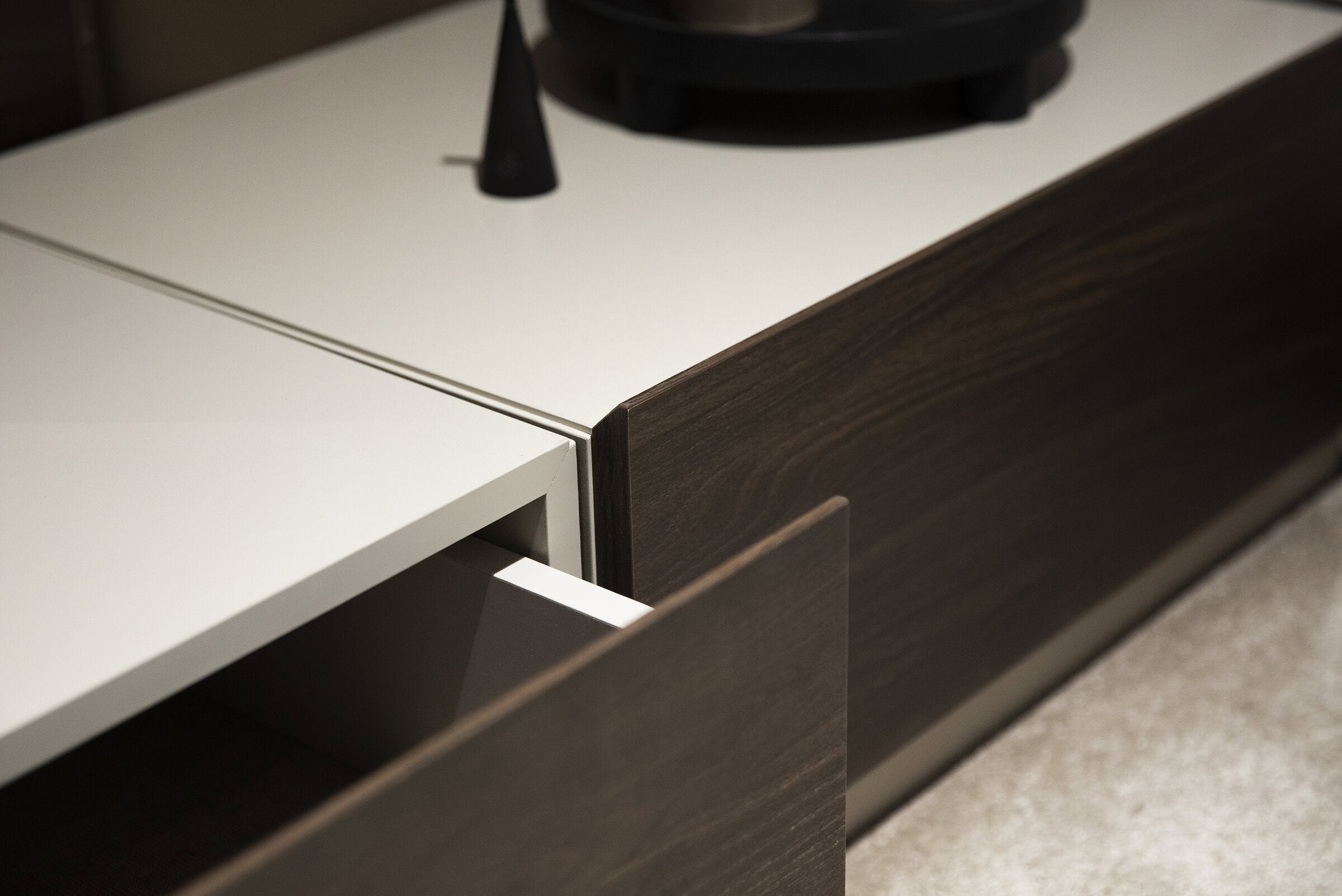 Drawer detail of modern contemporary custom furniture with dark wood and white finish, showcasing sleek design and high-quality craftsmanship.