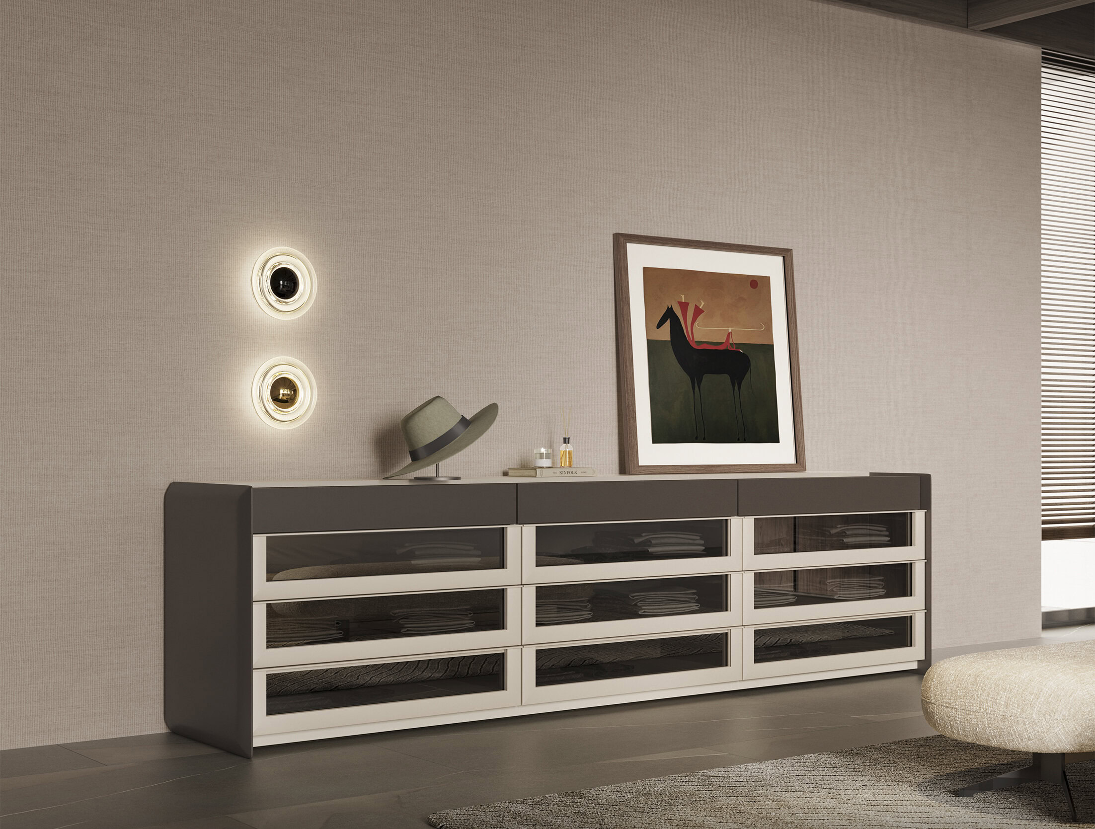 Sleek modern sideboard with glass-front drawers in black and white, placed against a textured beige wall with contemporary wall lights, topped with decorative accessories and artwork.
