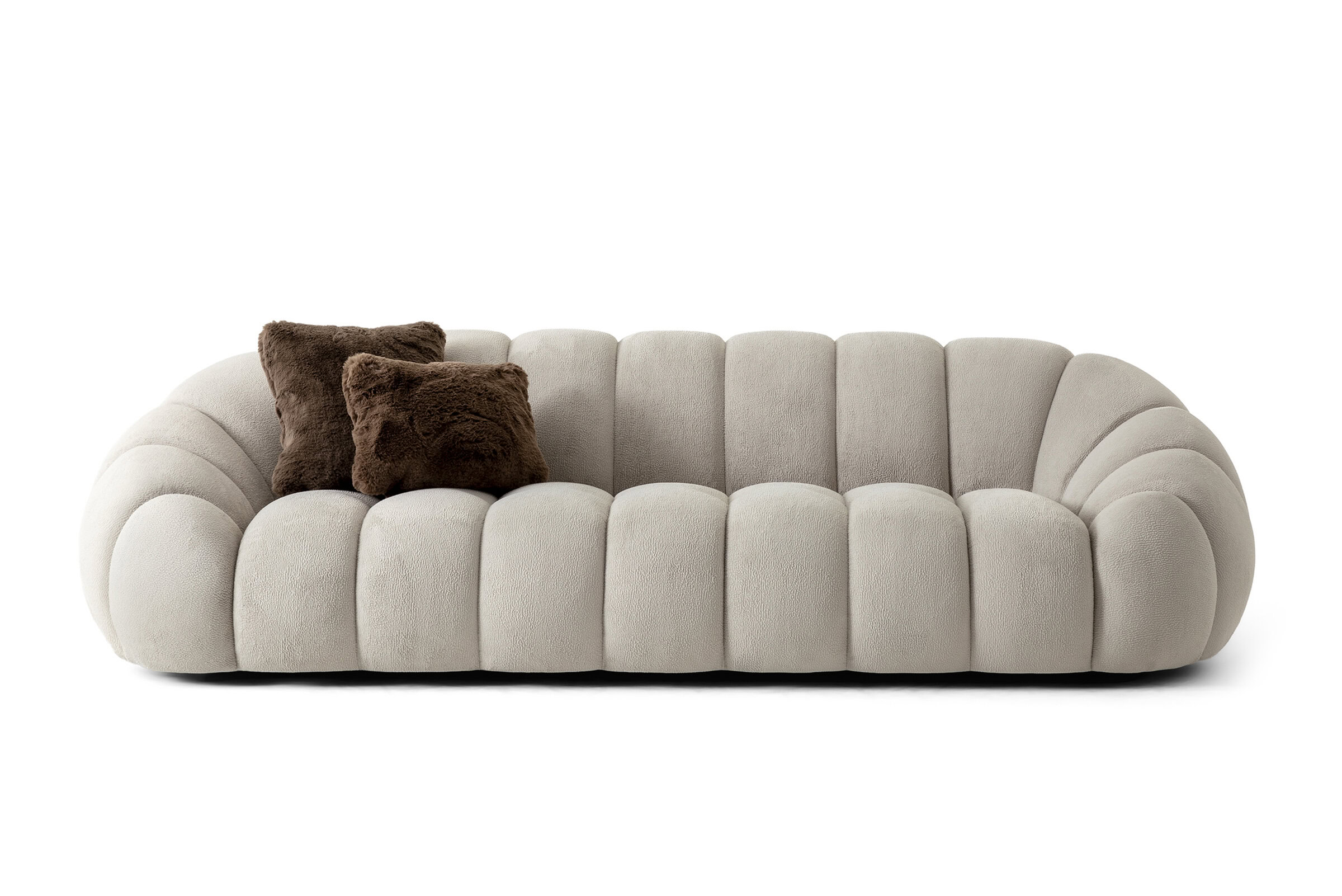 Elegant beige plush sofa with rounded design and brown accent pillows, perfect for contemporary living rooms and stylish home decor.