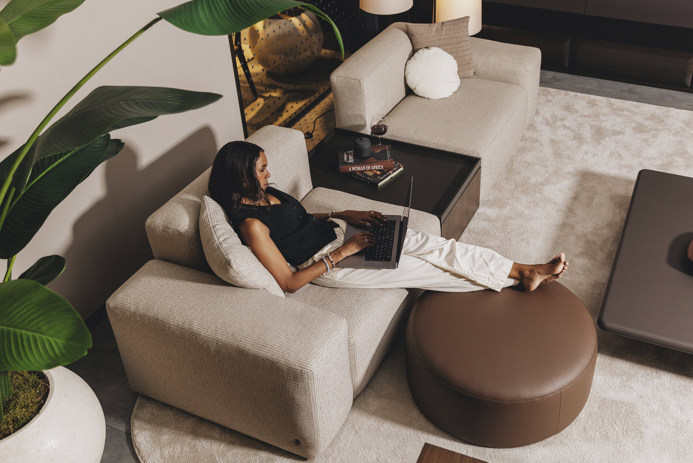 Comfortable beige sectional sofa with plush cushions perfect for modern living spaces and home offices.
