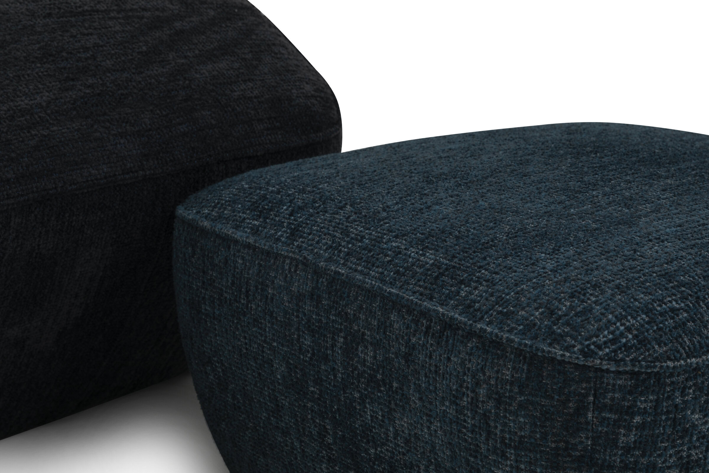 Soft, textured dark blue and black fabric upholstery on modern furniture pieces, showcasing durable and stylish materials perfect for contemporary home decor.