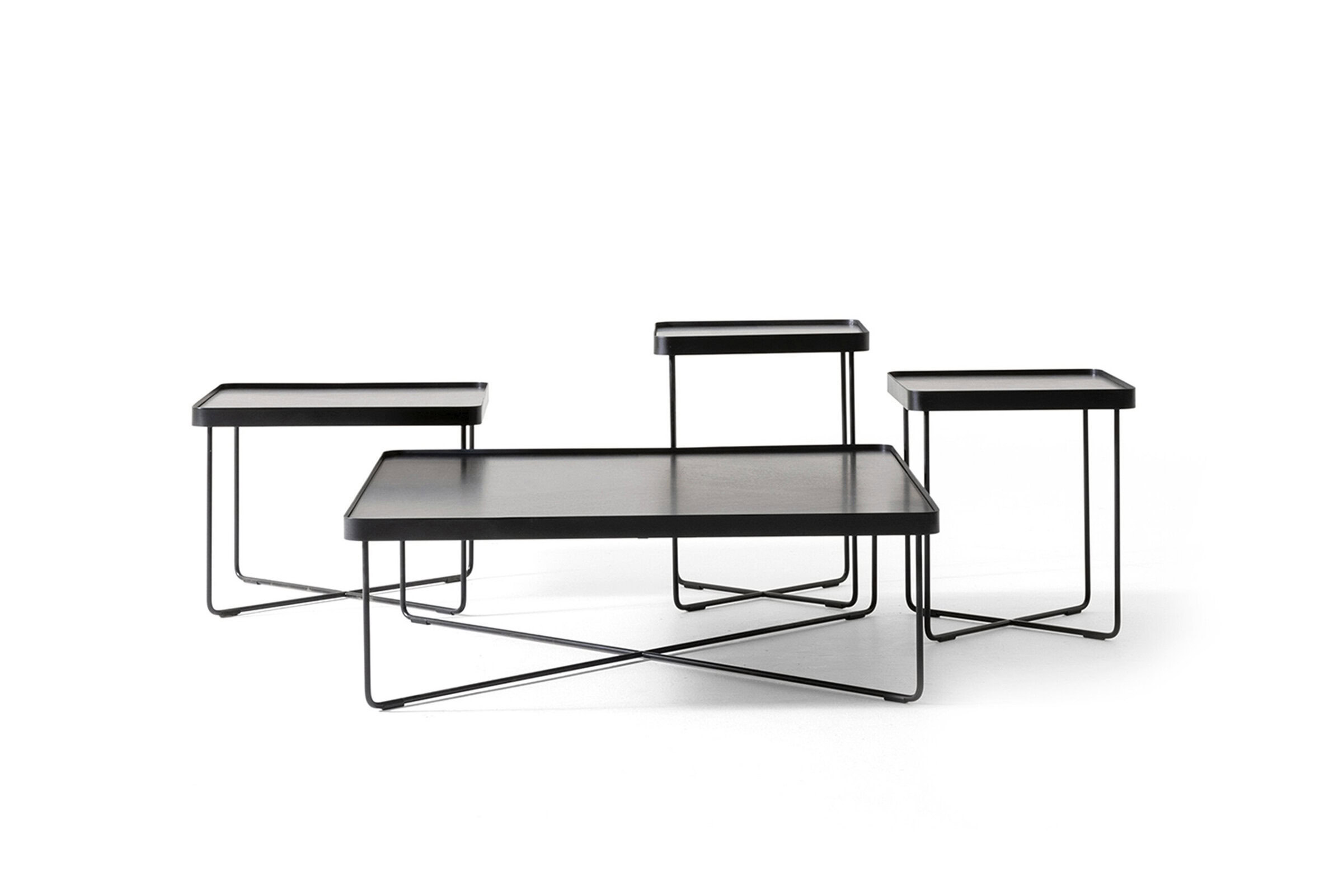 Sleek black nesting coffee tables with minimalist metal frames, perfect for modern living room decor and stylish furniture arrangements.