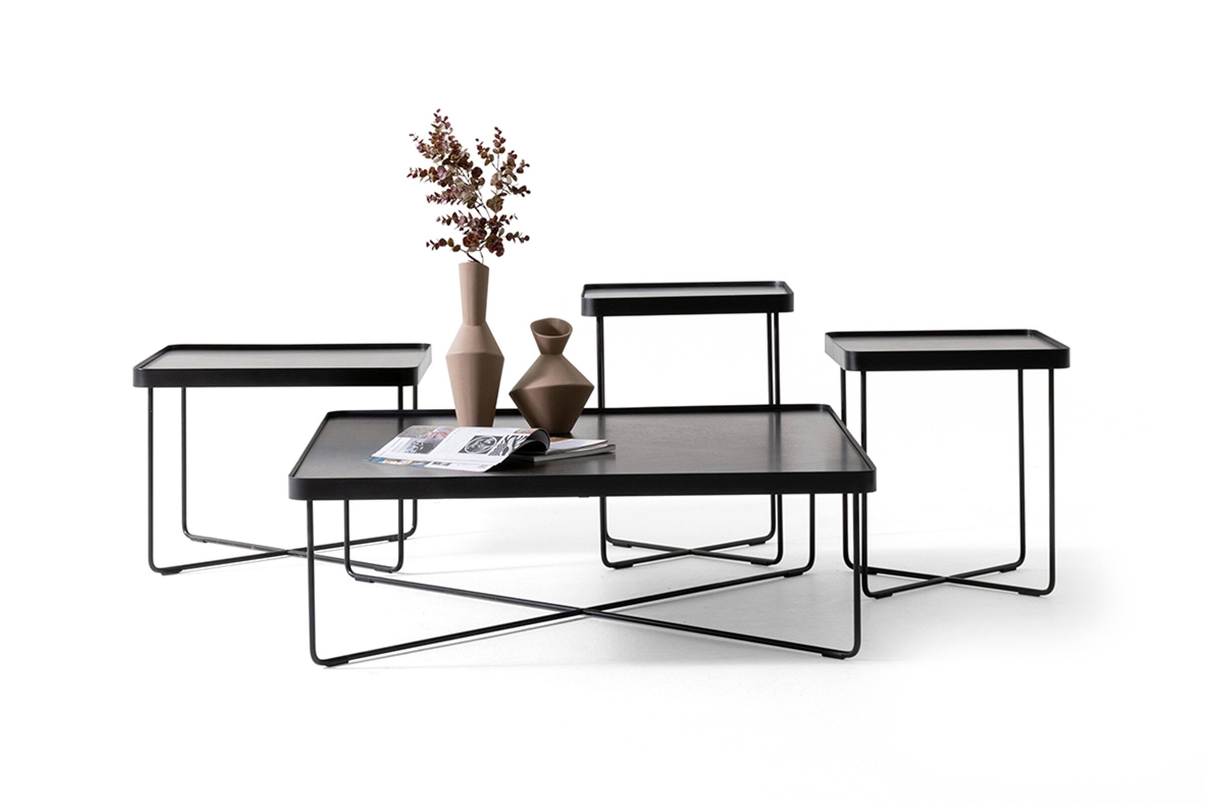 Sleek black metal nesting tables with glass tops, modern minimalist design, ideal for contemporary living room decor.