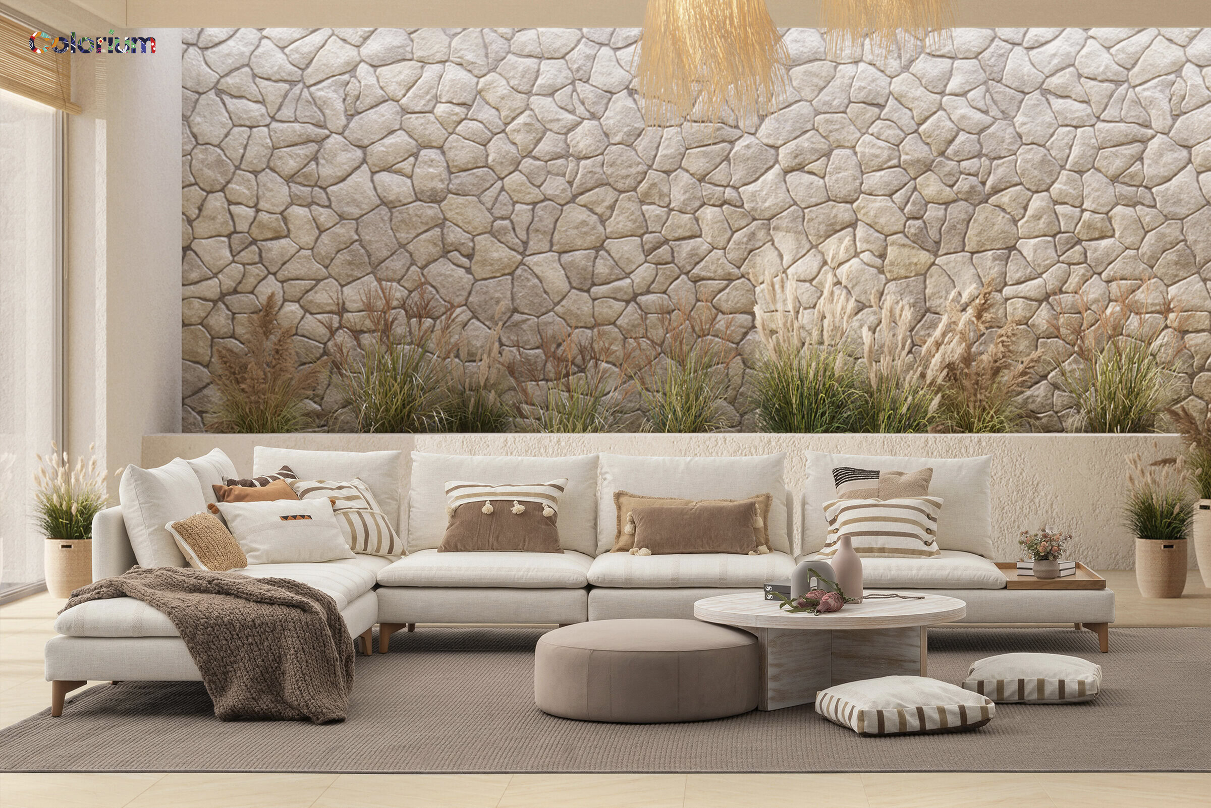 Elegant living room with a large white sectional sofa, stone accent wall, and cozy decor, showcasing stylish furniture from Saloni Furniture.