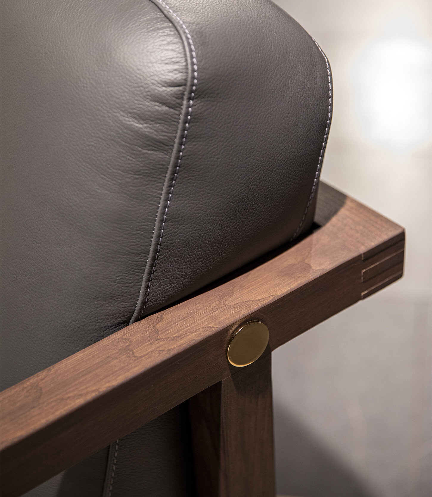 Contemporary leather armchair with wooden frame, stylish design, and premium craftsmanship, perfect for modern living spaces.