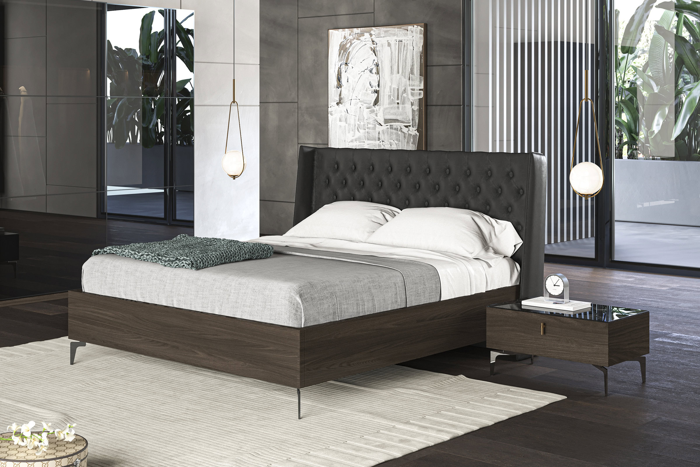 Sleek modern black upholstered bed with wooden frame and nightstand in contemporary bedroom decor with glass doors and greenery in the background.