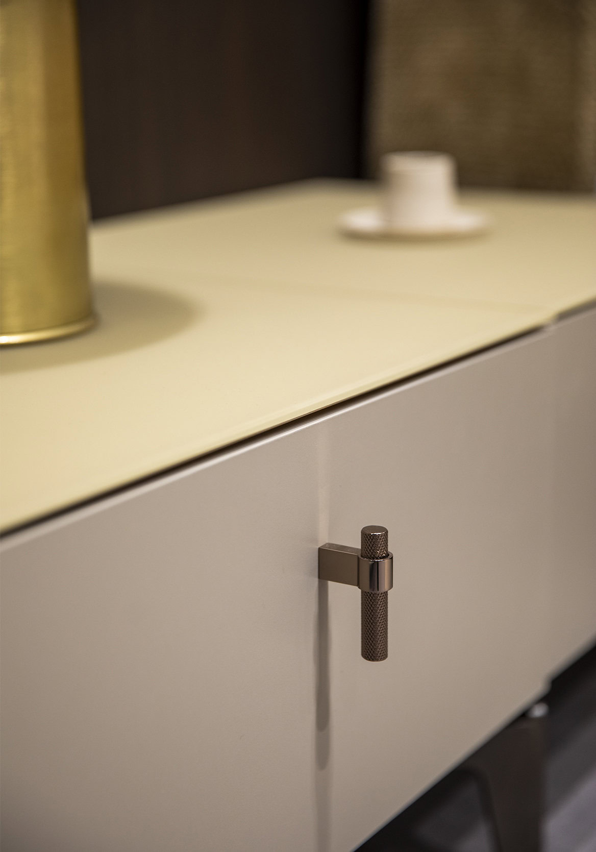 Elegant modern cabinet with sleek metallic handle, perfect for contemporary interior decor.