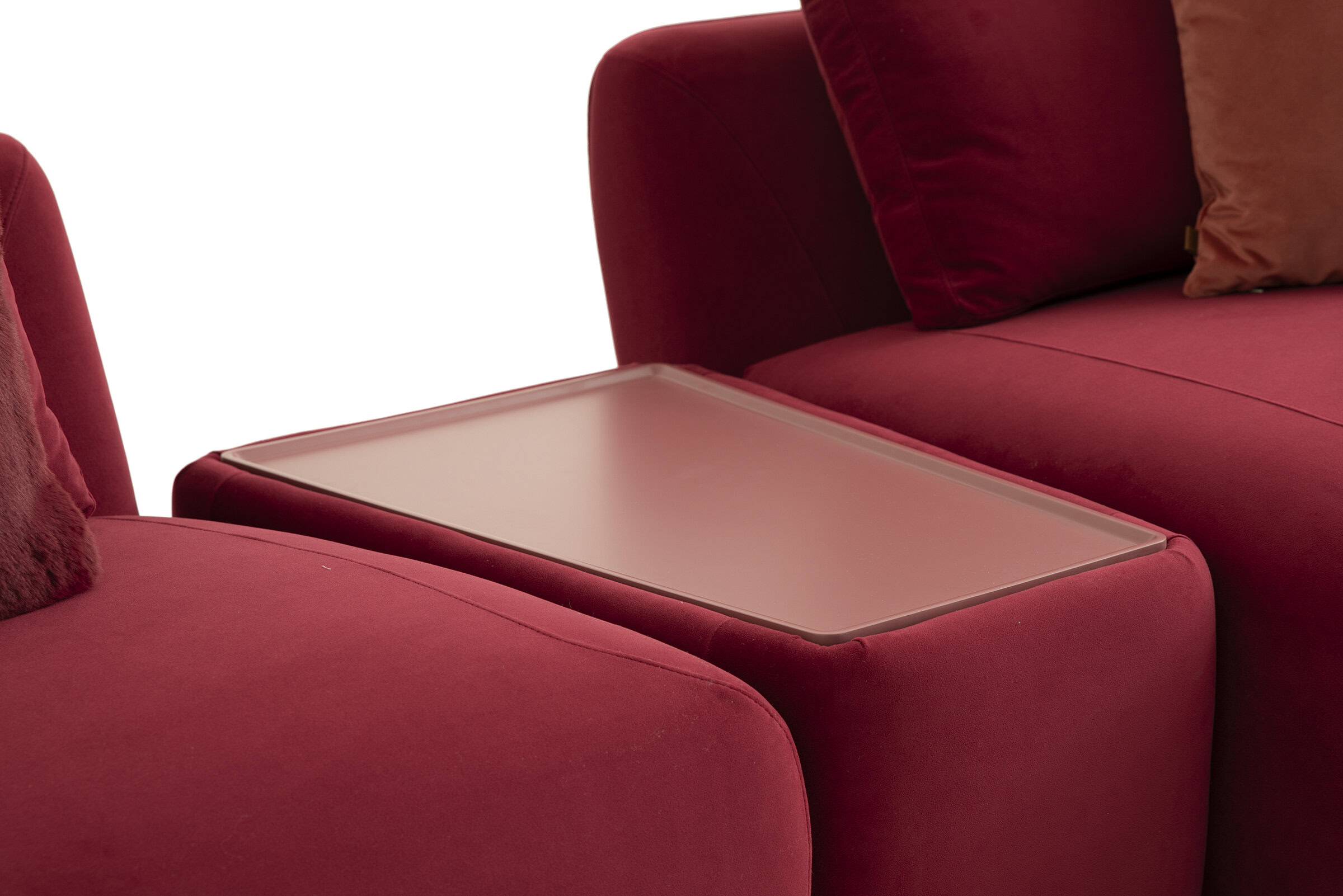 Modern red sofa with a sleek wooden side table for stylish living room decor.