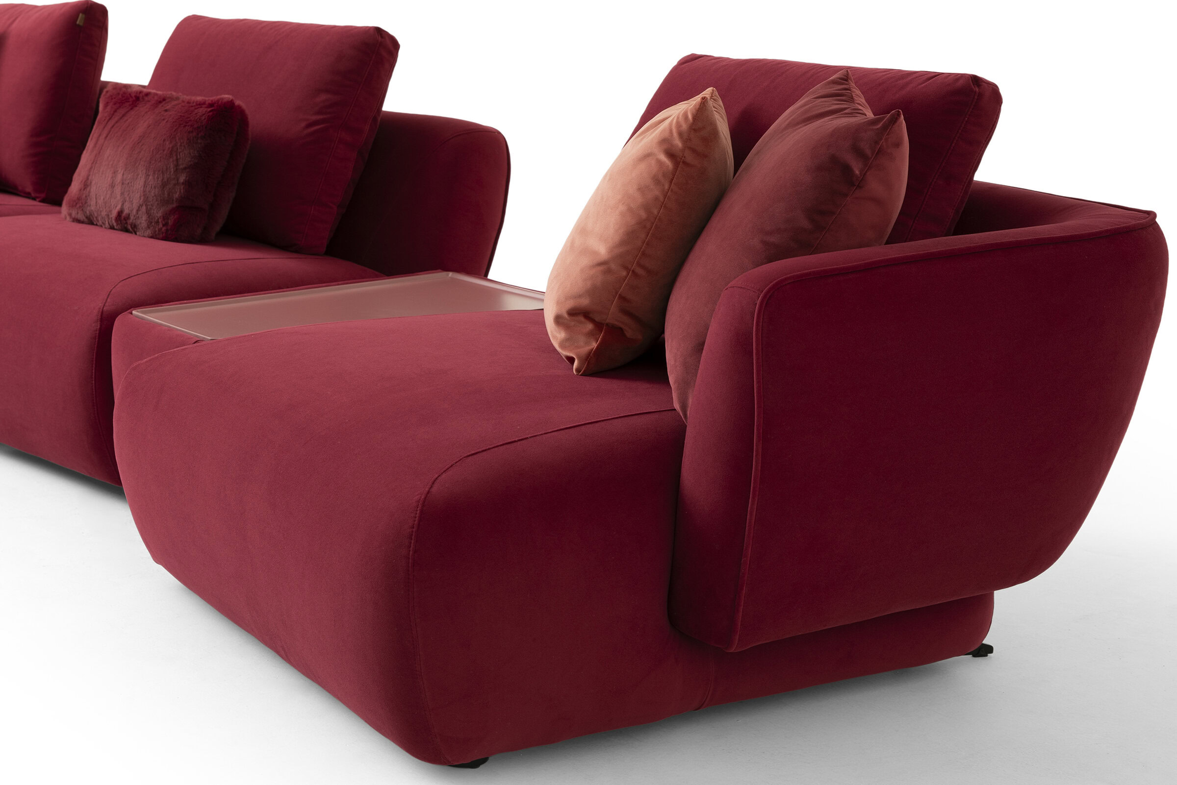Elegant red sofa with plush cushions and contemporary design, perfect for stylish living rooms and modern interiors.