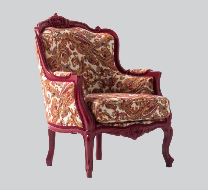 Luxurious vintage armchair featuring a carved wooden frame and intricate floral fabric upholstery, perfect for classic interior decor and adding timeless elegance to any living space.
