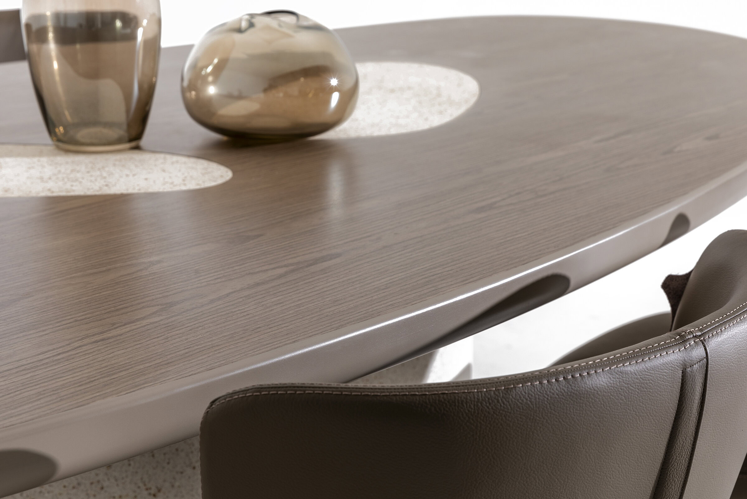 Elegant modern dining table made of high-quality wood with a smooth, polished finish, complemented by stylish decorative vases and placemats for a contemporary home décor.
