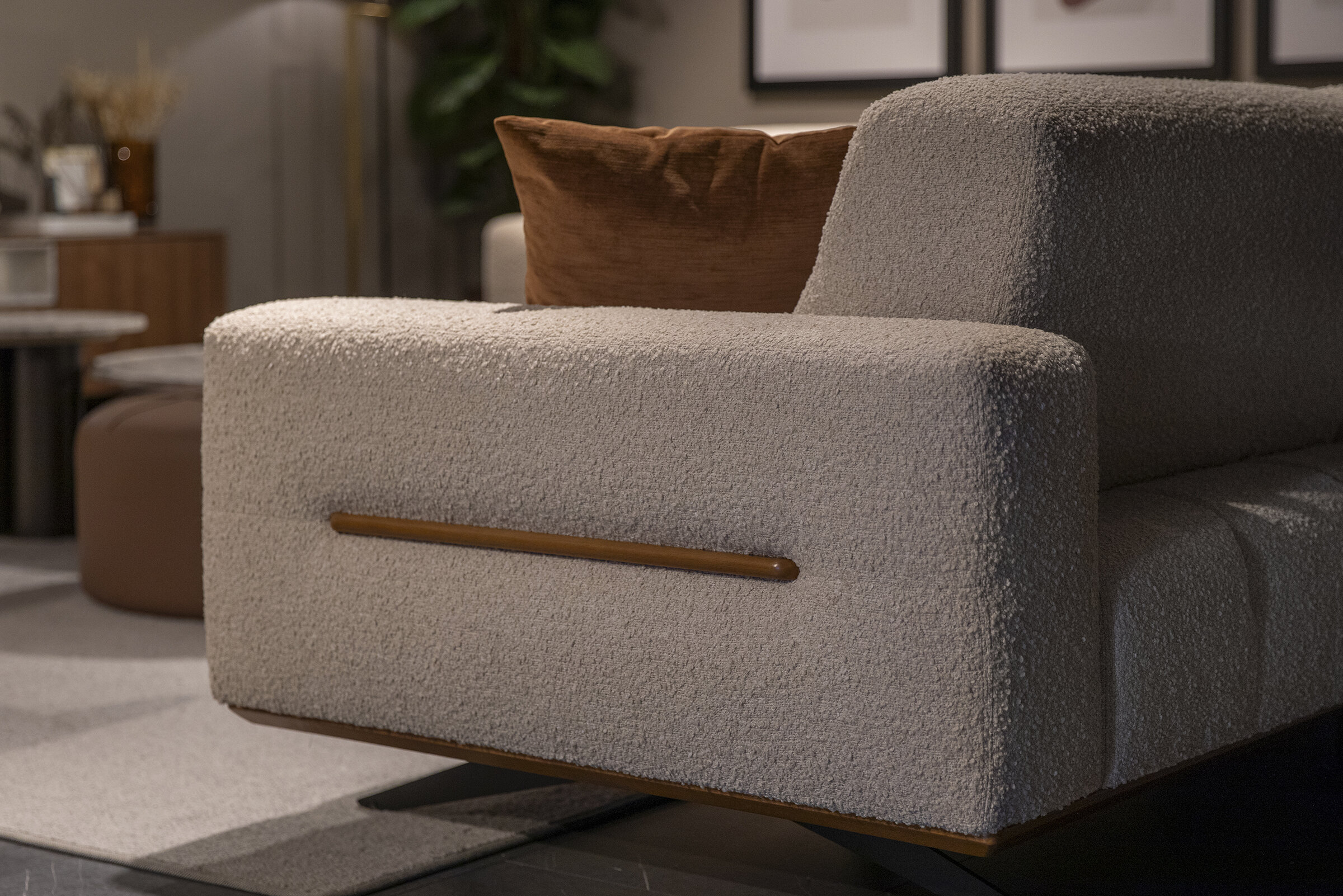Soft beige textured upholstered sofa with wooden accents, contemporary design, and cozy decor for stylish living rooms.