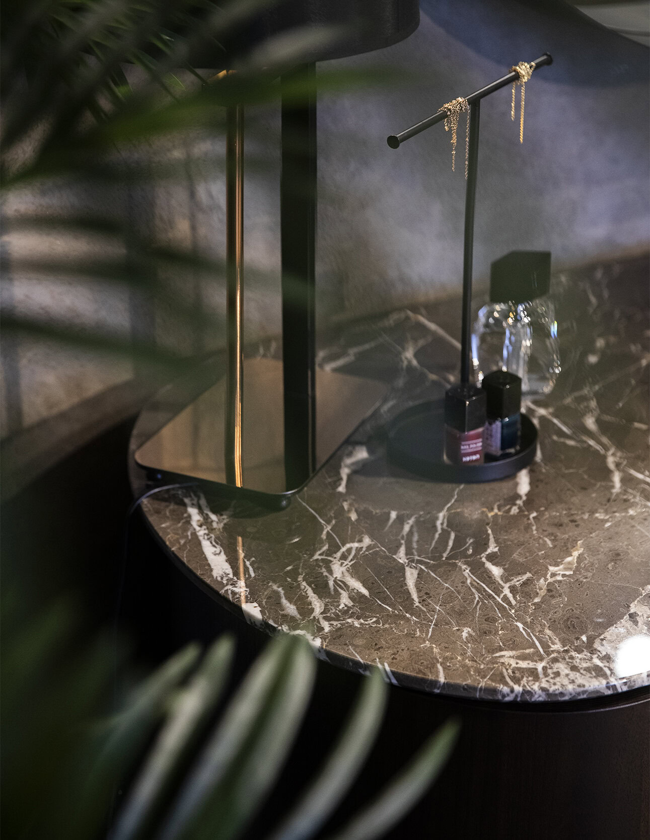 Polished marble top table with modern black and gold accessories for luxury home décor.