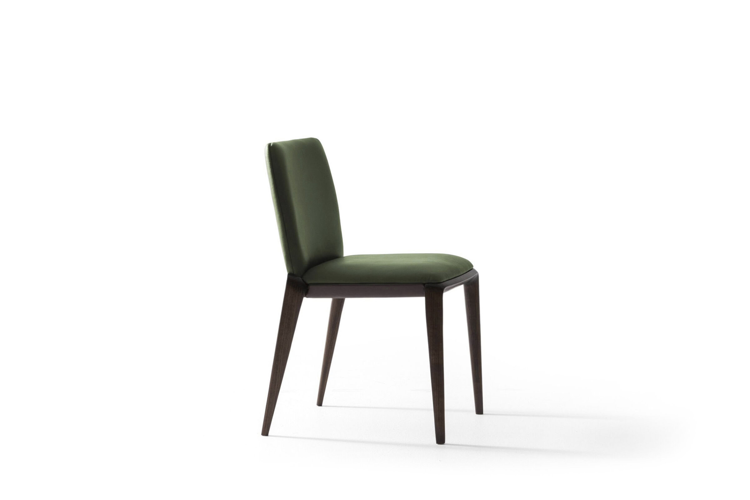 Luxury green upholstered dining chair with dark wood legs, modern furniture design for stylish interiors, Saloni Furniture.