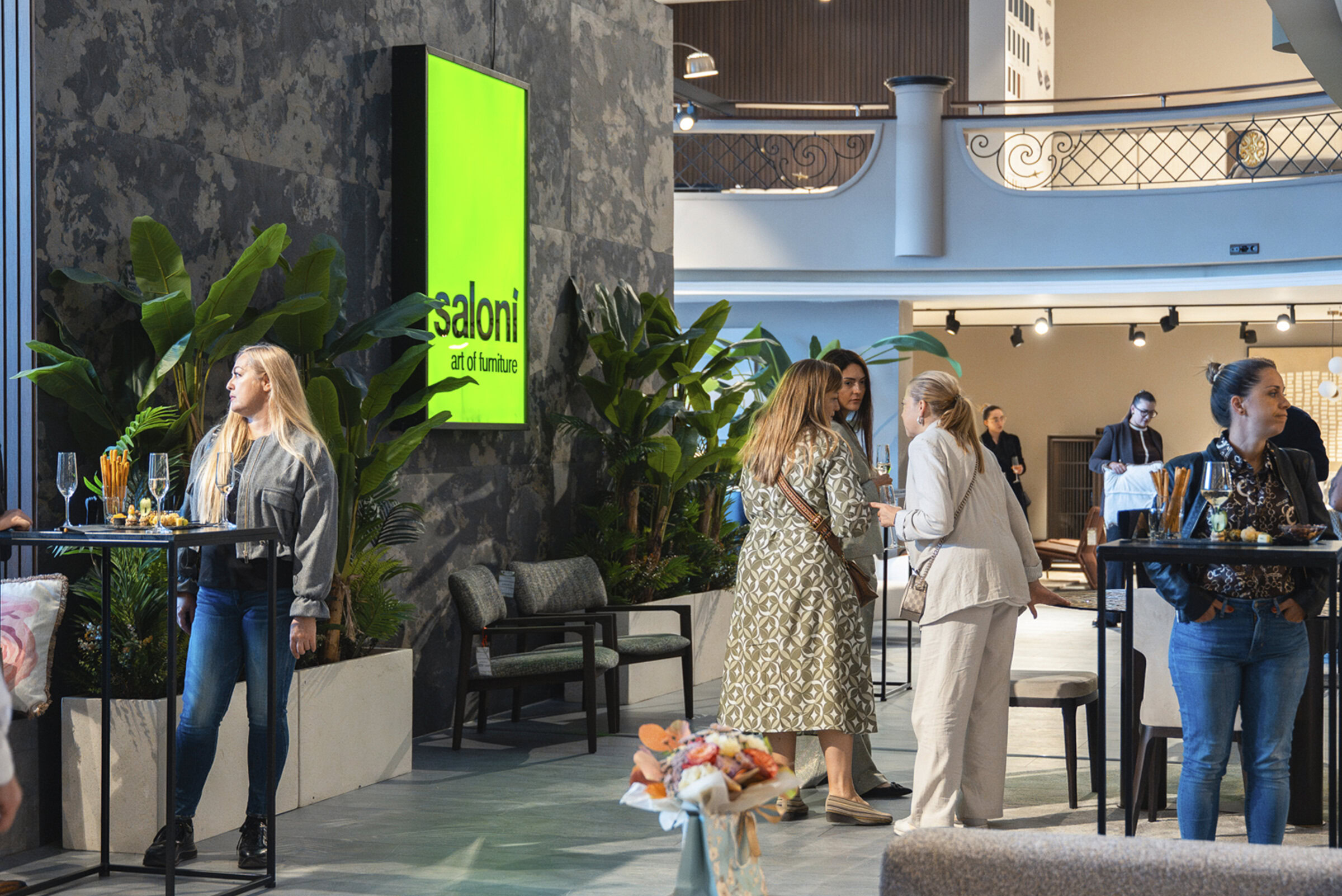 Saloni furniture modern showroom with stylish interior decor and people browsing furniture collections, highlighting contemporary furniture designs and elegant home furnishings.